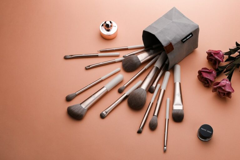 Makeup brushes presented in an editorial photograph, illustrative image for a luxury cosmetics buying guide